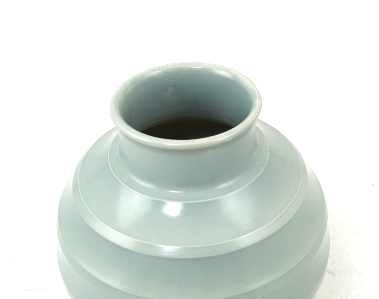 Keith Murray MC RDI FRIBA (New Zealand/British, 1892-1981) for Wedgwood: A pale blue glazed globe or 'bomb' vase